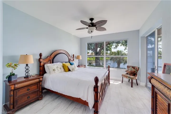Primary Bedroom with Lake View and private lanai access sliding door.