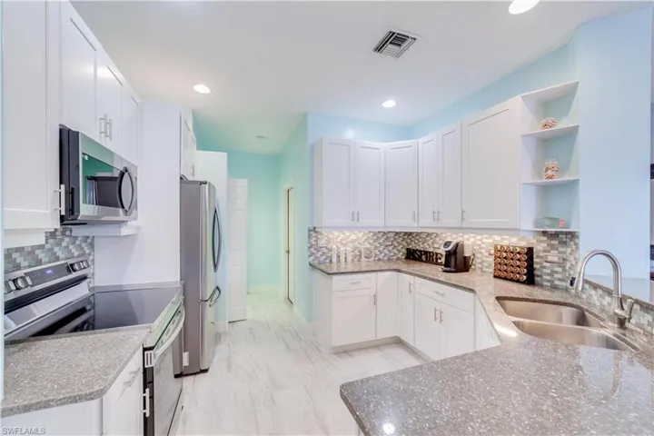 Kitchen Area w/ all new cabinets and stainless steel appliances.