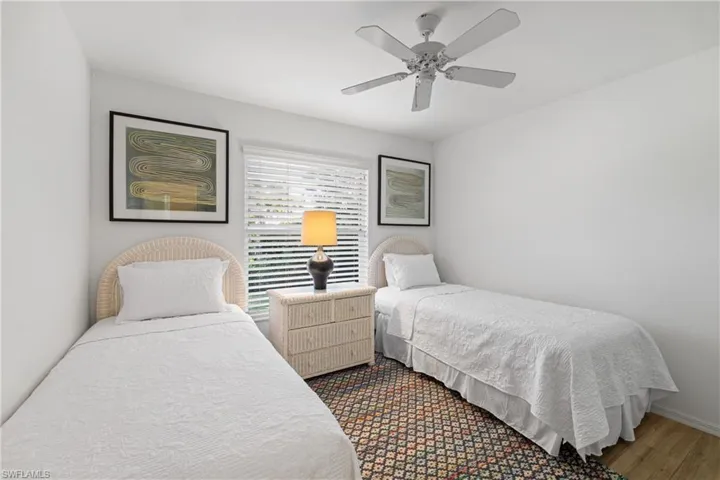 Bedroom with ceiling fan and hardwood / wood-style flooring