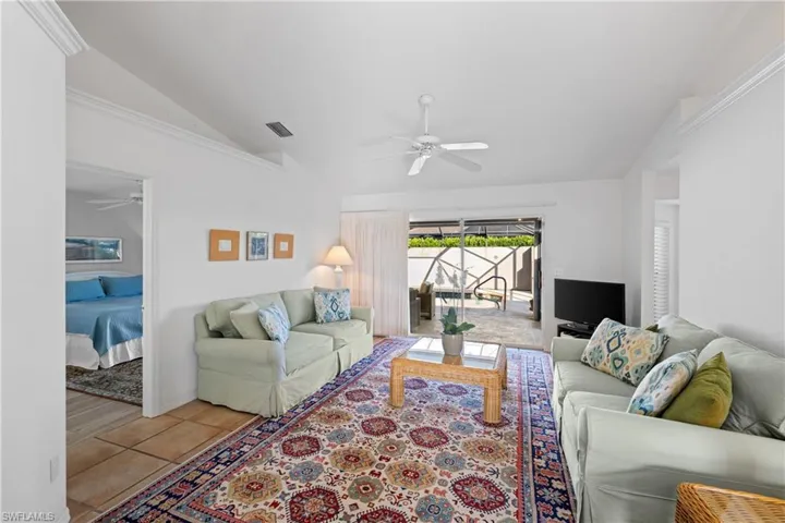 Living room featuring vaulted ceiling and light tile patterned floors