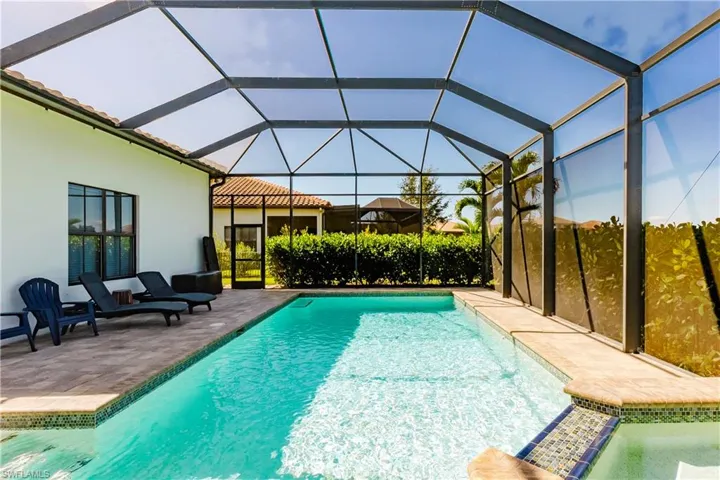 Swimming pool featuring a patio area, a lanai, and a sunroom