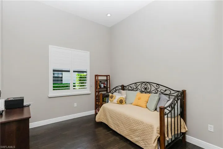 Bedroom with dark wood-style floors and recessed lighting