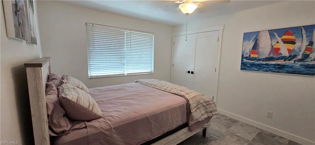 Bedroom with baseboards and ceiling fan