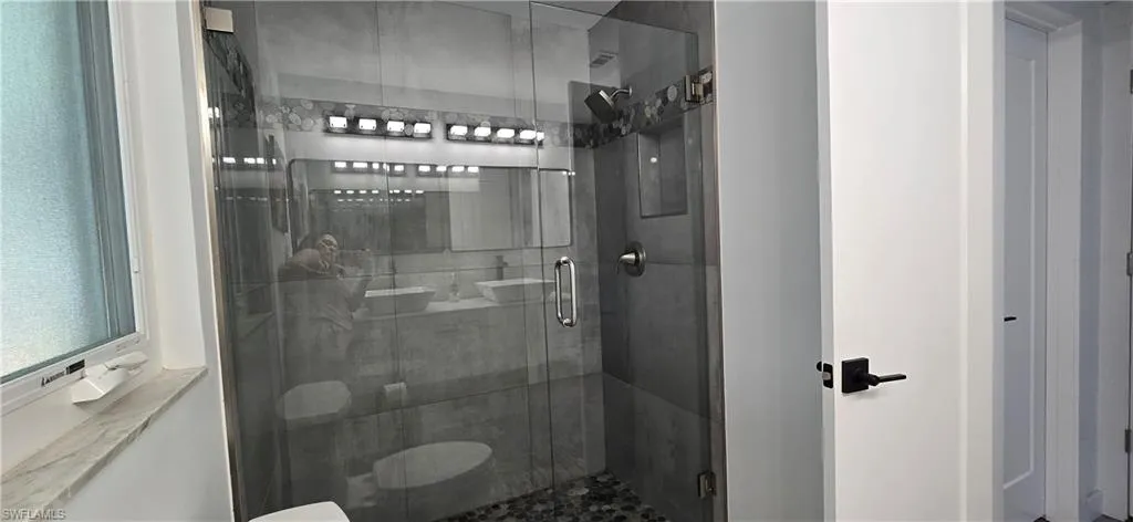 Full bathroom featuring a shower stall
