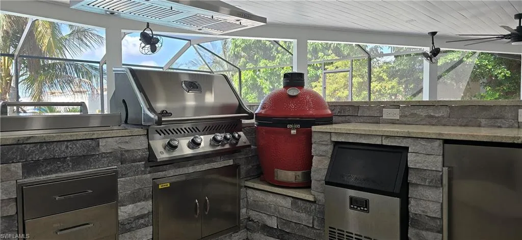 View of patio / terrace featuring exterior kitchen, grilling area, and a lanai