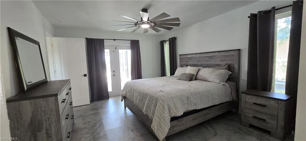 Bedroom featuring access to exterior and a ceiling fan