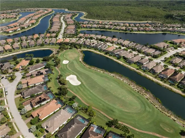 Expansive golf course with sand traps and water features