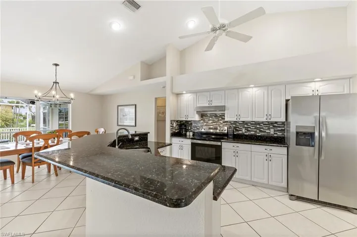 Kitchen with breakfast bar and stainless appliances
