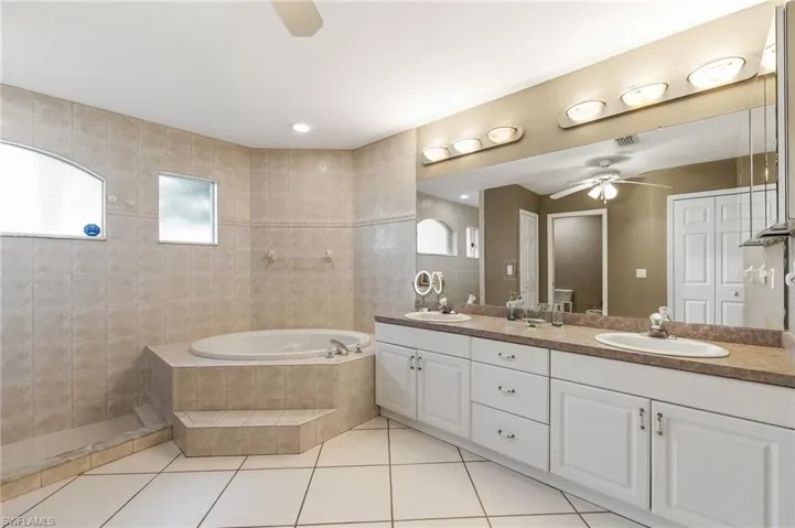 primary ensuite with walk-in shower and garden tub
