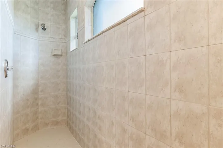 walk in tile shower in primary ensuite