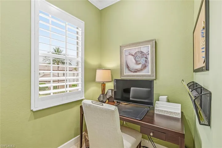 Office with a textured wall, healthy amount of natural light, and crown molding
