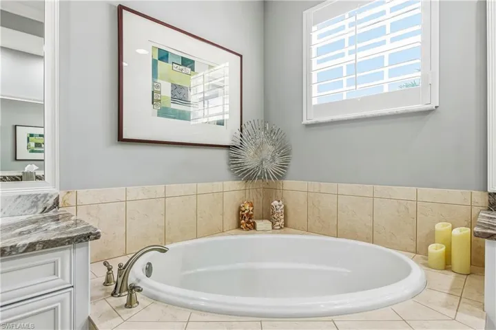 Bathroom featuring a bath and vanity