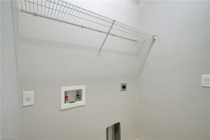 Clothes washing area with hookup for a washing machine and hookup for an electric dryer