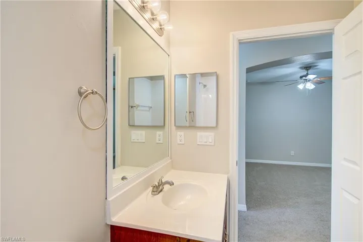 Bathroom with ceiling fan and vanity