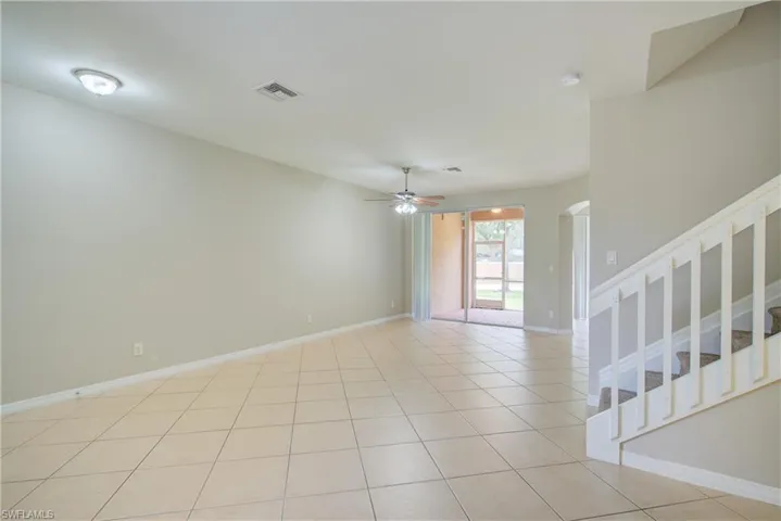 Tiled empty room with ceiling fan