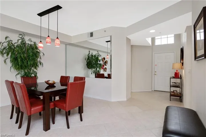 Dining area featuring light tile patterned flooring and baseboards