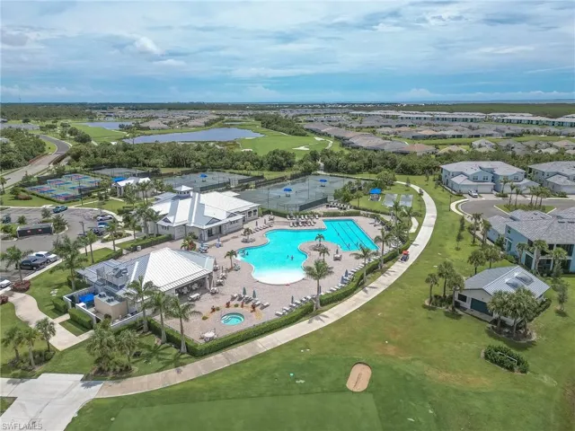 Aerial view of property's location with a large body of water and nearby suburban area