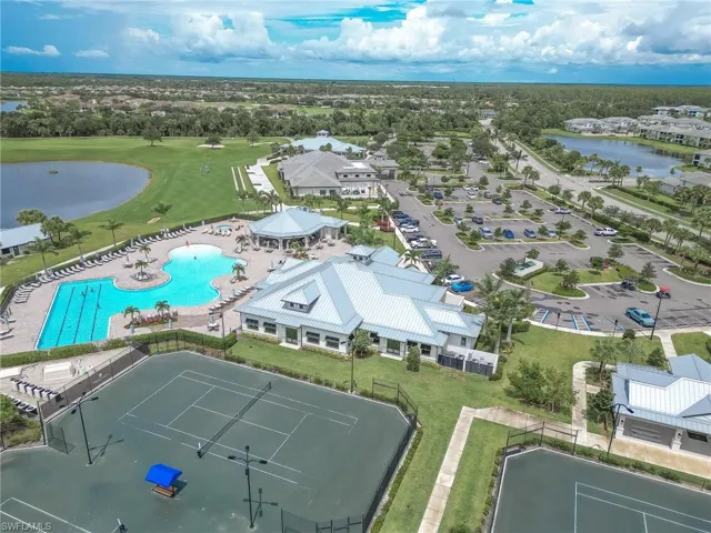 Drone / aerial view of a pool area and a nearby body of water