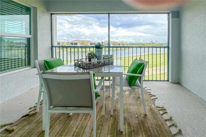 Sunroom / solarium with healthy amount of natural light and a water view