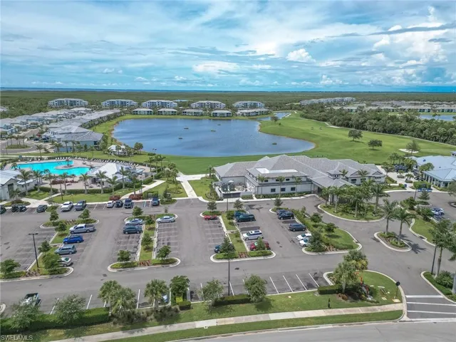 Drone / aerial view of a large body of water and a local golf course