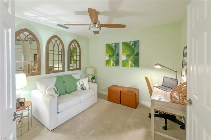 Carpeted office featuring baseboards and ceiling fan