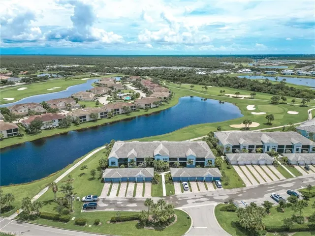 Aerial view of residential area with a golf course and a large body of water