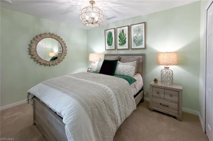 Bedroom with carpet and a chandelier