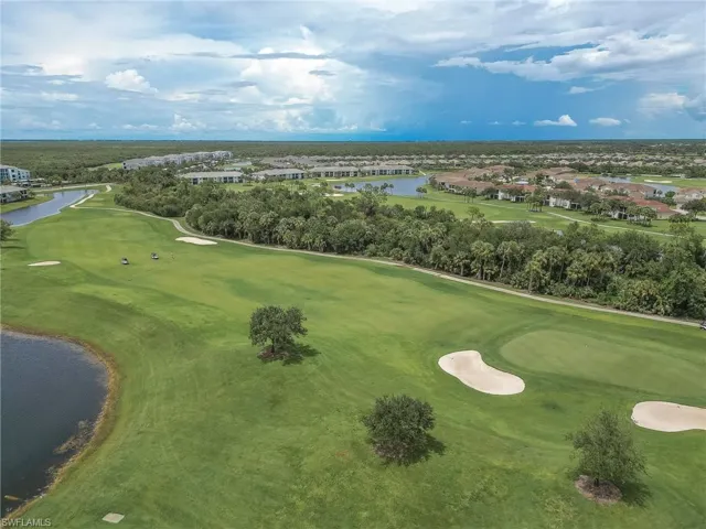 Drone / aerial view of a nearby body of water and a local golf course