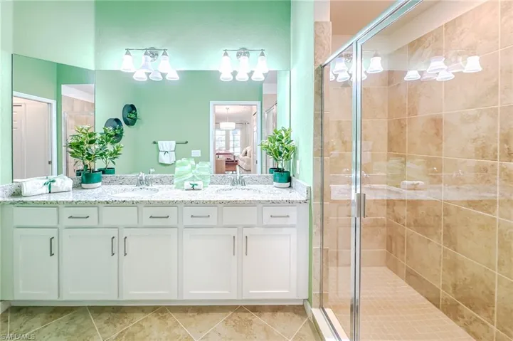 Ensuite bathroom with double vanity and a shower stall