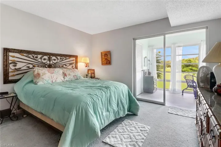 Carpeted bedroom featuring a textured ceiling