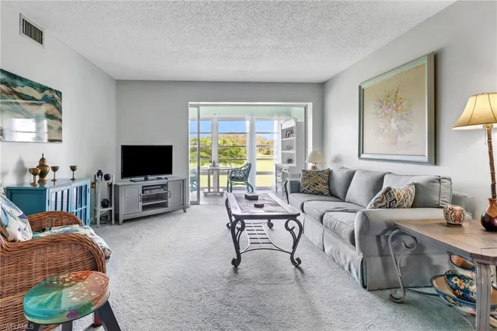 Living room with a textured ceiling and carpet