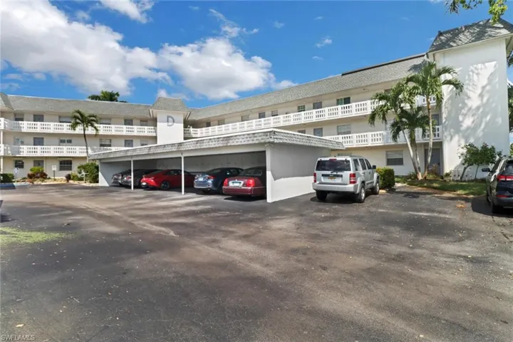 View of parking with a carport