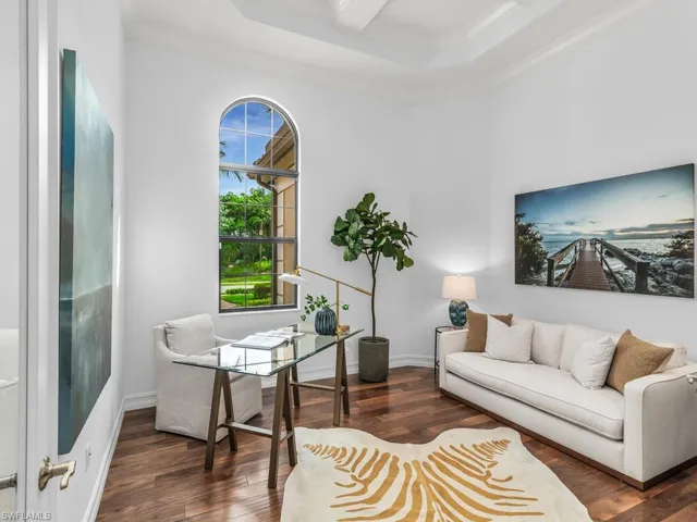 Office area featuring dark hardwood style floors and ornamental molding.