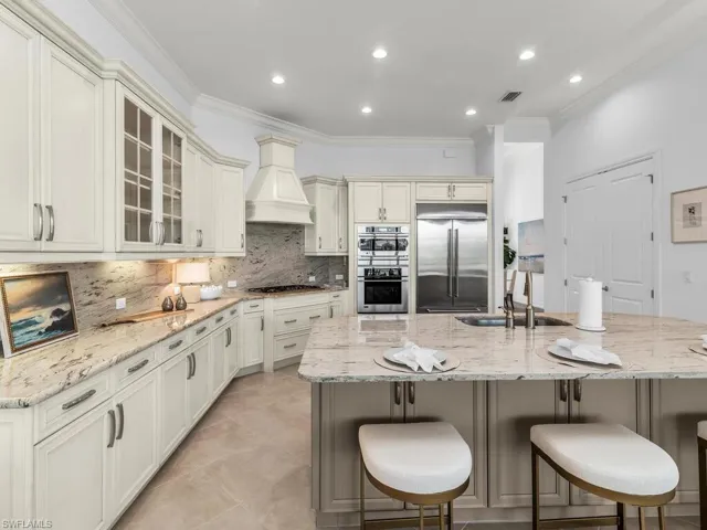 Kitchen is finished with custom range hood and premium refrigerator.