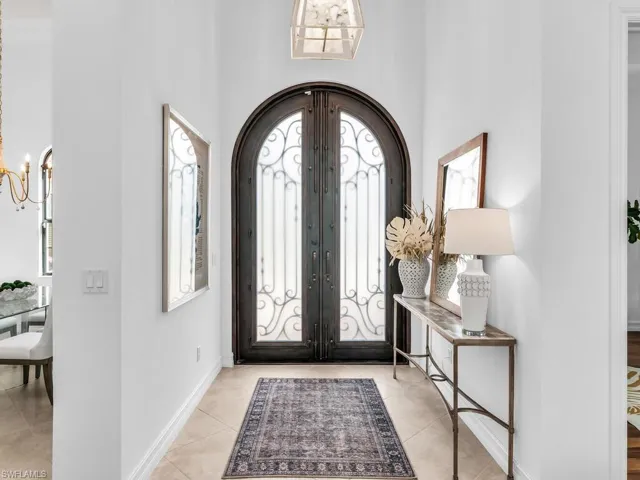Entrance foyer featuring custom iron and glass French doors.