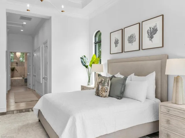 French doors leading to primary bedroom with his and hers custom closets.