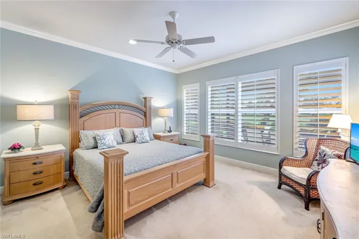Spacious Primary Bedroom with Crown Molding, Plantation Shutters and recessed lighting.