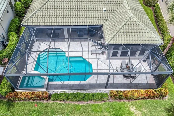 View of subject property featuring a pool
