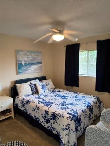 Bedroom featuring carpet and ceiling fan