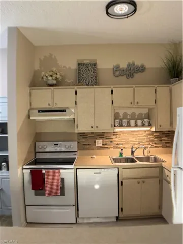 Kitchen featuring stove, light countertops, dishwasher, tasteful backsplash, and extractor fan