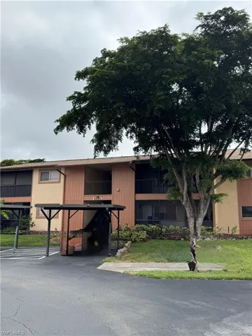 View of property with covered parking