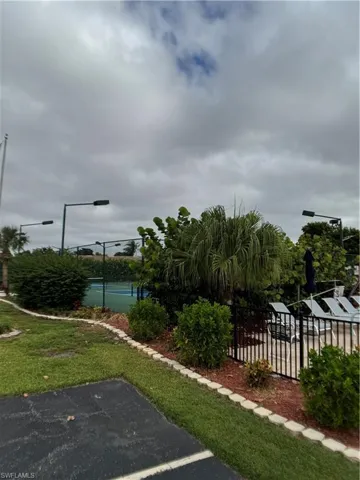 View of home's community with a tennis court