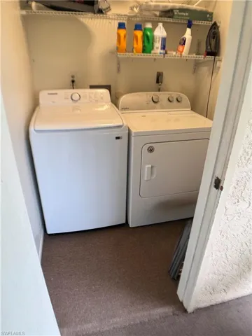 Laundry room with washing machine and clothes dryer