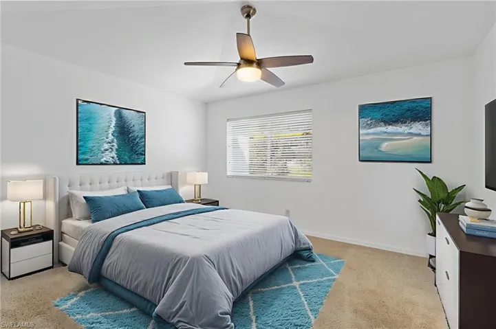 Bedroom featuring a ceiling fan and light colored carpet