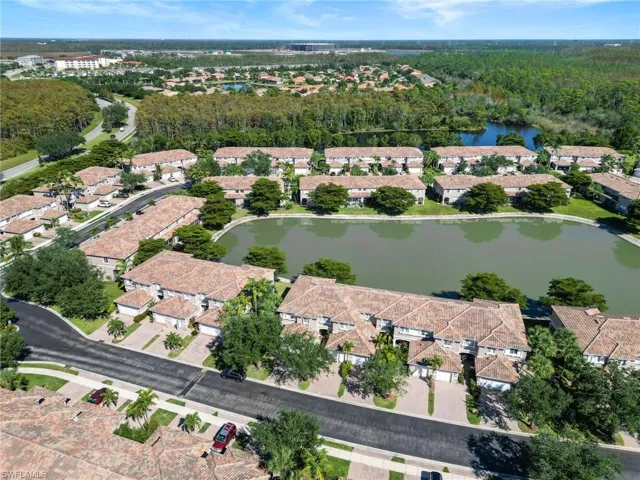 Aerial view of property and surrounding area with nearby suburban area and a large body of water