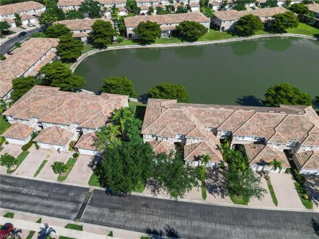 Aerial view of property's location with a large body of water and nearby suburban area