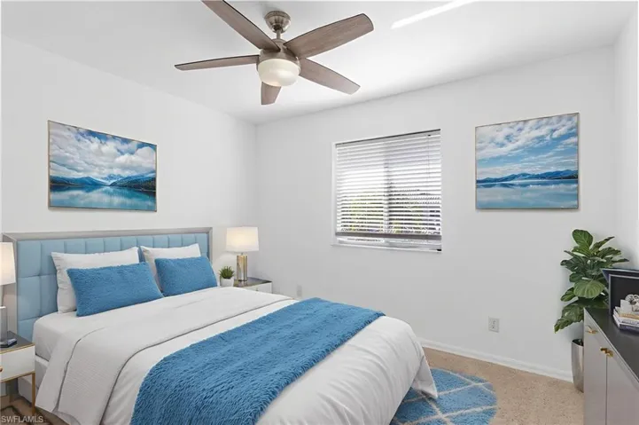 Bedroom featuring light colored carpet and a ceiling fan