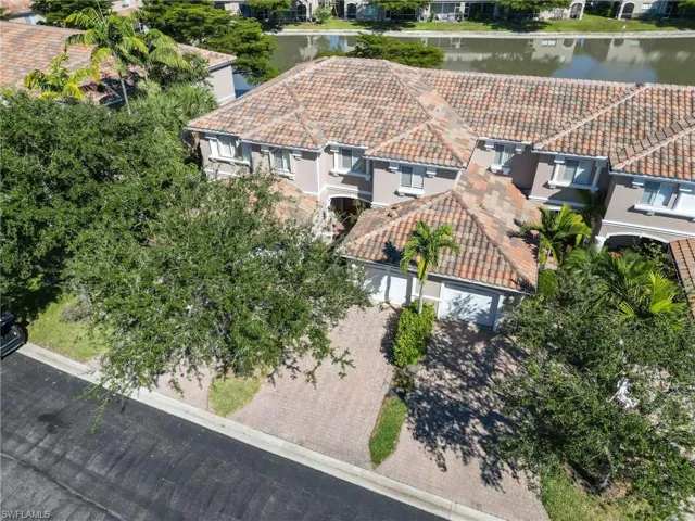 Aerial view of property and surrounding area featuring a nearby body of water
