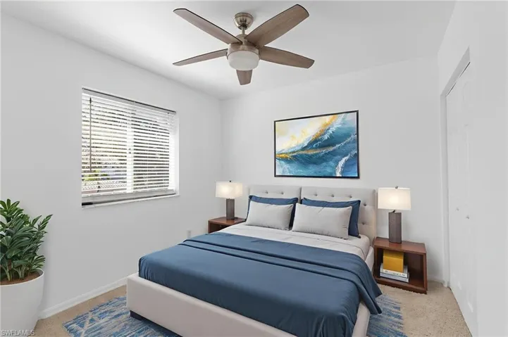 Bedroom featuring carpet, a ceiling fan, and a closet