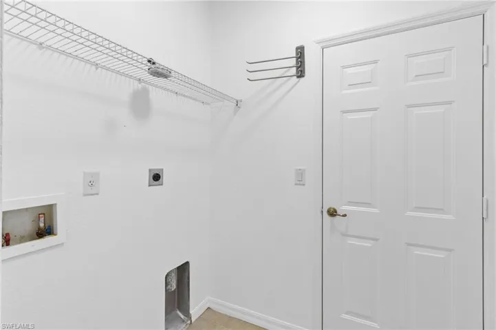 Laundry room featuring hookup for an electric dryer, washer hookup, and light tile patterned floors